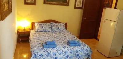 a bedroom with a bed with two blue towels on it at Apartman Veliki Pijesak in Dobra Voda