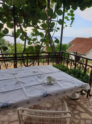 a white table with a bowl on top of it at Apartman Veliki Pijesak in Dobra Voda