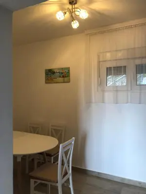 a dining room with a table and chairs at Viola Apartmanházak Family Apartman in Donji Susanj