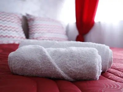 a pile of towels sitting on top of a bed at Apartment Mona in Podgorica