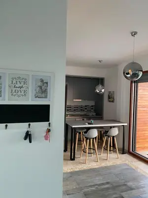 a kitchen with a table and stools in a room at Bitcoin and Ethereum Deluxe Apartments in Bar