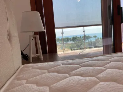 a bedroom with a bed and a window with a view at Bitcoin and Ethereum Deluxe Apartments in Bar