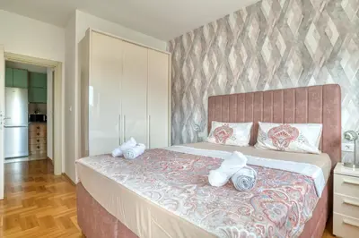 a bedroom with a large bed with towels on it at Azure Apartments in Budva