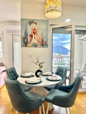 a dining room with a table and chairs at Azure Apartments in Budva