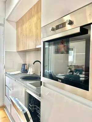 a kitchen with a sink and a microwave at Azure Apartments in Budva