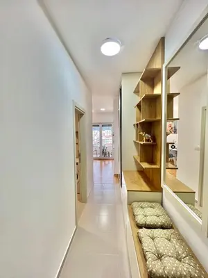 a hallway of a home with a shelf and a hallway with a hallway at Azure Apartments in Budva