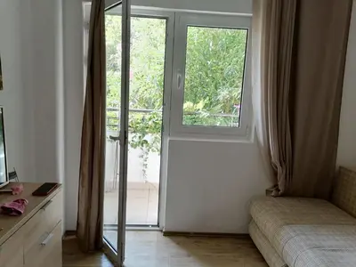 a room with a sliding glass door and a couch at Candy apartment central location Bečići in Becici