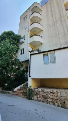 a tall building with stairs leading up to it at Candy apartment central location Bečići in Becici
