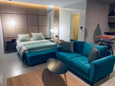 a living room with a bed and a couch at Le petit bonheur in Ulcinj