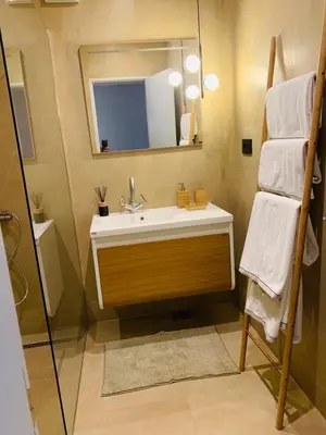 a bathroom with a sink and a mirror and towels at Le petit bonheur in Ulcinj