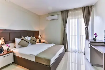 a bedroom with a large bed and a large window at Atlantic sobe in Dobra Voda