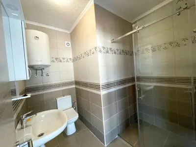 a bathroom with a toilet and a sink and a shower at UpART House in Petrovac na Moru