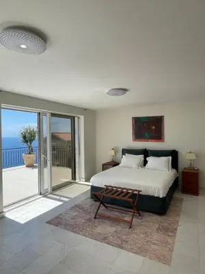 a bedroom with a bed and a view of the ocean at Villa Portico in Budva