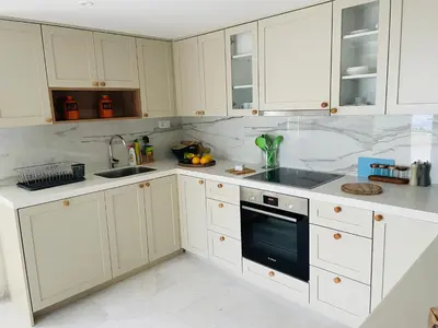 a white kitchen with white cabinets and a sink at Villa Portico in Budva