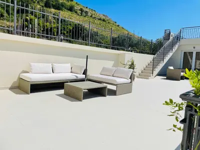 a patio with two couches and a coffee table at Villa Portico in Budva