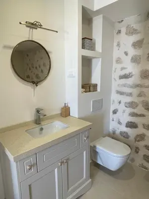 a bathroom with a sink and a toilet and a mirror at Villa Portico in Budva