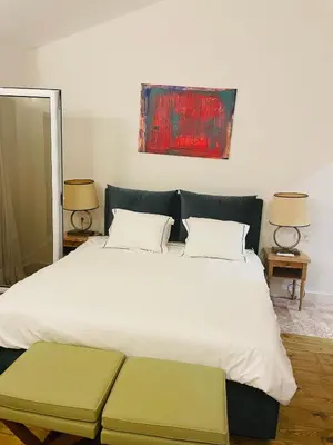 a bedroom with a large white bed with two pillows at Villa Portico in Budva