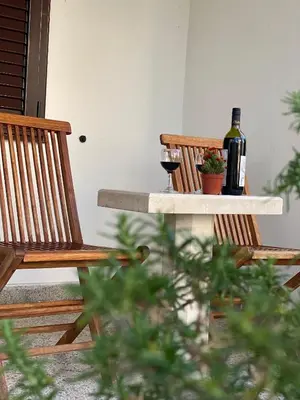 two bottles and two glasses of wine sitting on a table at Guest house Kamelija in Budva