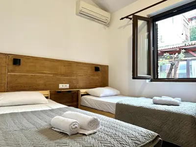 a room with two beds with towels on them at Guest house Kamelija in Budva