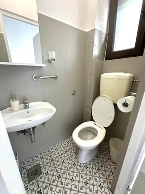 a bathroom with a toilet and a sink at Guest house Kamelija in Budva