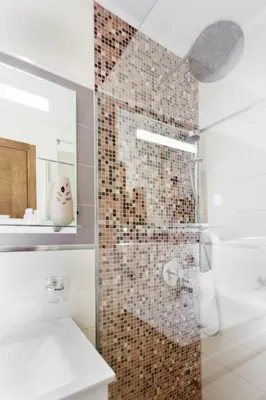 a bathroom with a shower with a glass door at Top-hill stunning view 2 bdr apt with swimming pool in Komoševina