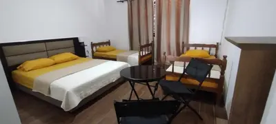 a bedroom with two beds and a table and chairs at Vila Arb in Ulcinj