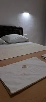 a white towel sitting on top of two beds at Vila Arb in Ulcinj