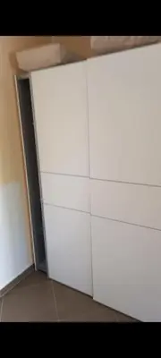 a room with white cabinets and an open door at MD Apartmani Canj in Čanj