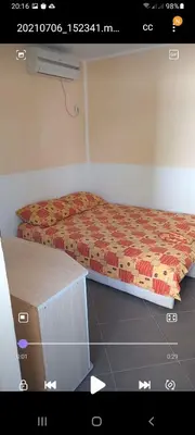 a bedroom with a bed and a dresser with avertisement at MD Apartmani Canj in Čanj