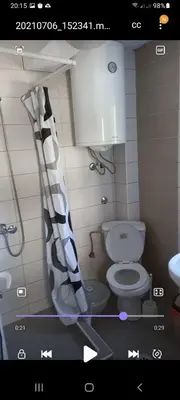 a bathroom with a toilet and a shower curtain at MD Apartmani Canj in Čanj