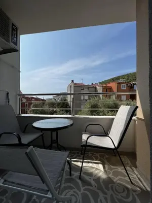 a balcony with two chairs and a table on a building at Budva Centar in Budva