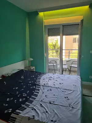 a bedroom with a bed and a view of a patio at Budva Centar in Budva