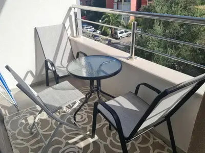 a balcony with chairs and a table and a window at Budva Centar in Budva