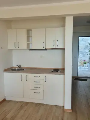 a kitchen with white cabinets and a sink at Villa Blanca in Petrovac na Moru