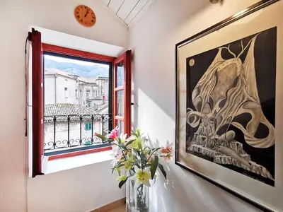 a window with a vase of flowers and a picture at OLD TOWN 303 in Kotor