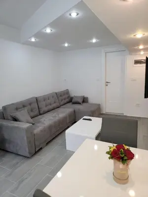 a living room with a couch and a table at Apartment Diamond -modern and lovely seaside studio apartment in Kotor