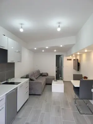 a kitchen and living room with a couch and a table at Apartment Diamond -modern and lovely seaside studio apartment in Kotor