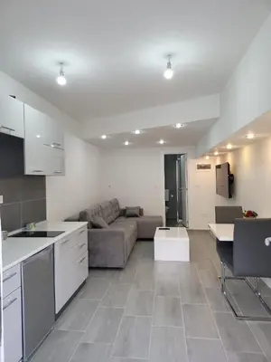a kitchen and living room with a couch and a table at Apartment Diamond -modern and lovely seaside studio apartment in Kotor