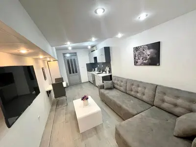 a living room with a couch and a table at Apartment Diamond -modern and lovely seaside studio apartment in Kotor