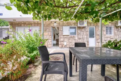 a black table and chairs in front of a building at Pearl of Budva in Budva
