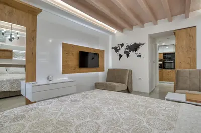 a bedroom with a large bed and a tv at Pearl of Budva in Budva