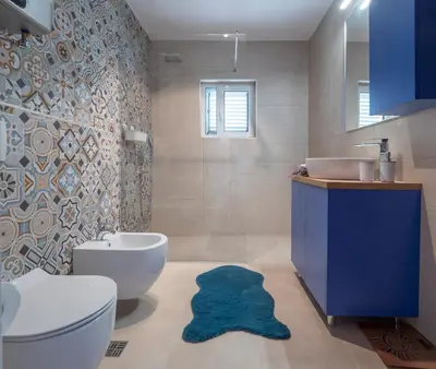 a bathroom with a white toilet and a sink at Villa Tranquila in Budva