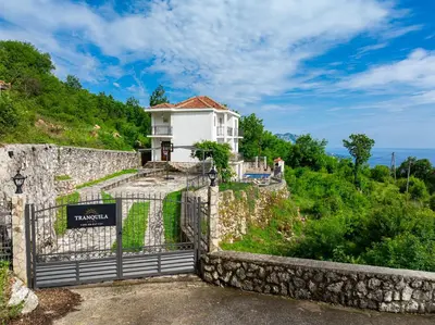 a house on the side of a hill with a gate at Villa Tranquila in Budva