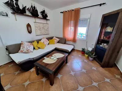 a living room with a couch and a coffee table at Sunset in Ulcinj