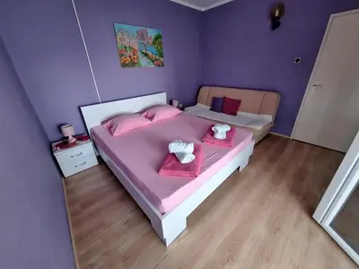 a bedroom with two beds with pink sheets and pink towels at Sunset in Ulcinj