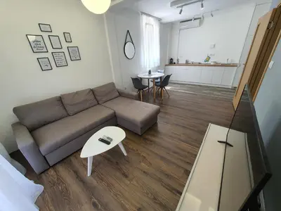 a living room with a couch and a table at JOX Apartment in Podgorica