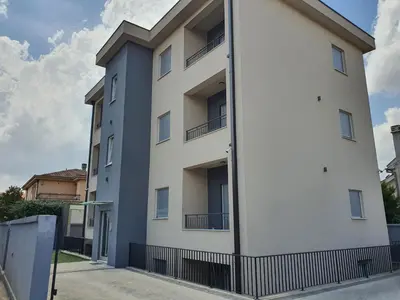a white building with balconies on the side of it at JOX Apartment in Podgorica