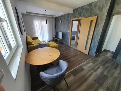 a living room with a table and a couch at JOX Apartment in Podgorica