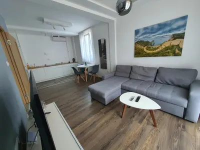 a living room with a couch and a table at JOX Apartment in Podgorica