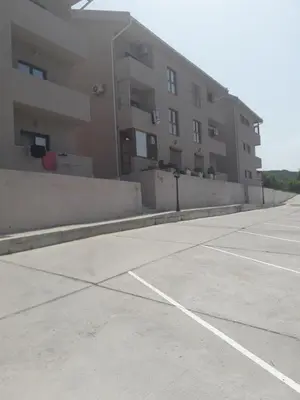 an empty parking lot in front of a building at Jovan Vukovic in Kotor